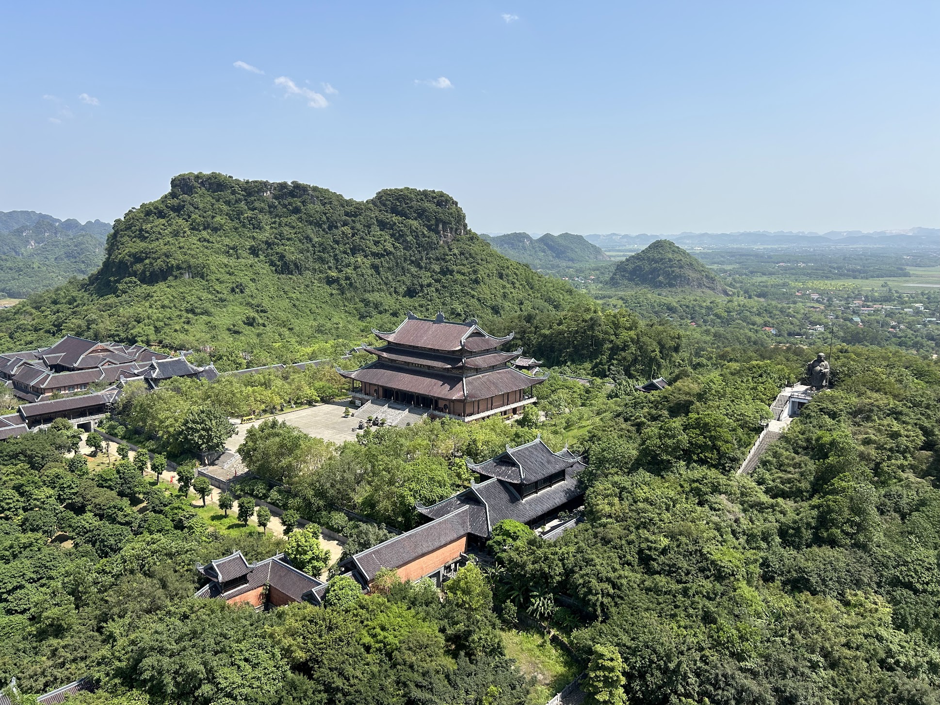 A temple complex among lush green limestone mountains