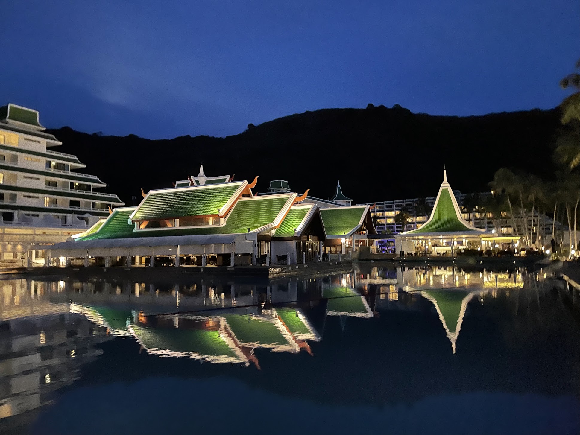 A waterfront resort illuminated at night