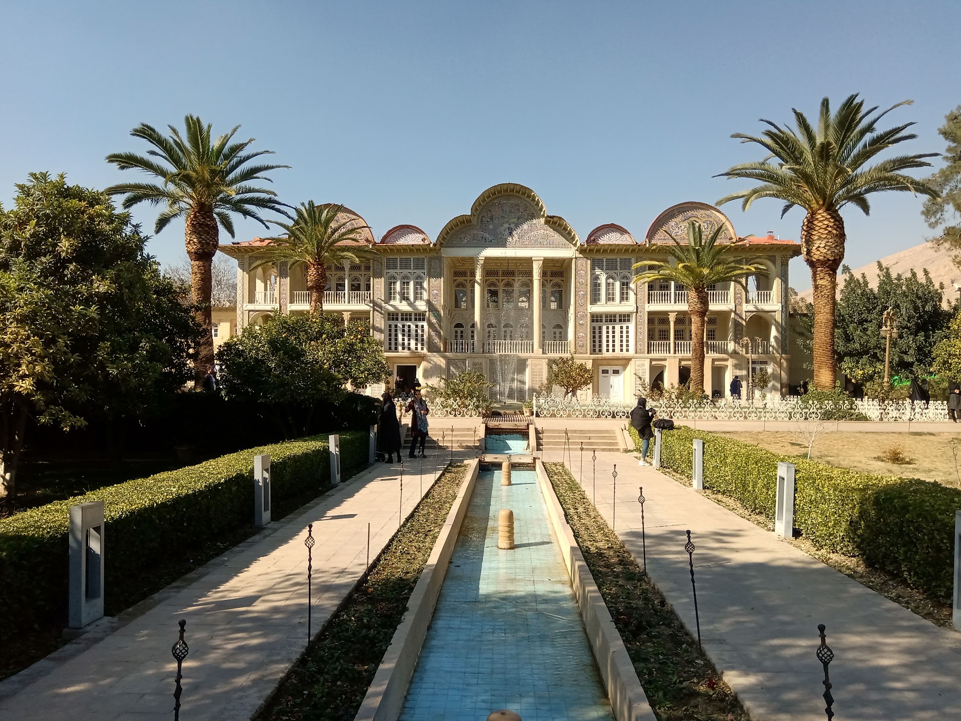 A historic Persian garden framed by palm trees